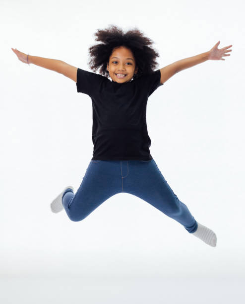 hip hop gi Happy and fun African American black kid jumping with hands raised isolated over white background