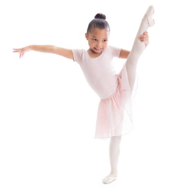 ballet g leg Cute preschool age African American female ballerina stretches out her leg in ballet pose.